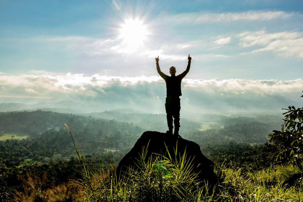 istock man backlight soaking the amazing view of mountain layers covered with white mist at dawn 1224079288