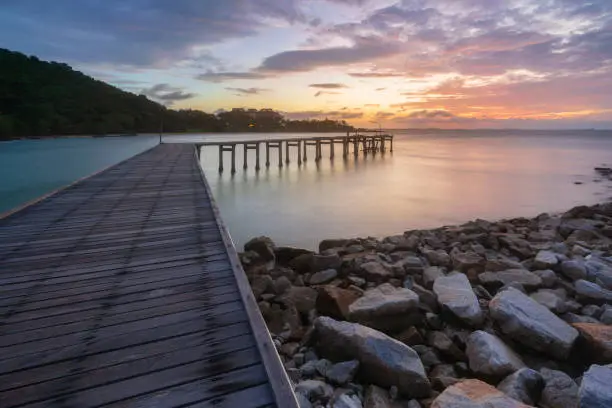 Wooden plank pier with seasacpe and evening sky for relax time at Khao Leam Ya National Park, Rayong Province, Thailand
