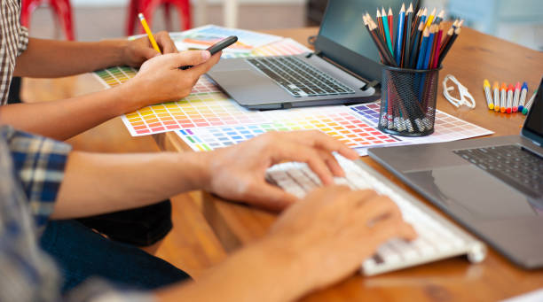 istock Two designers work on a desk with a laptop in the office. 1224081515