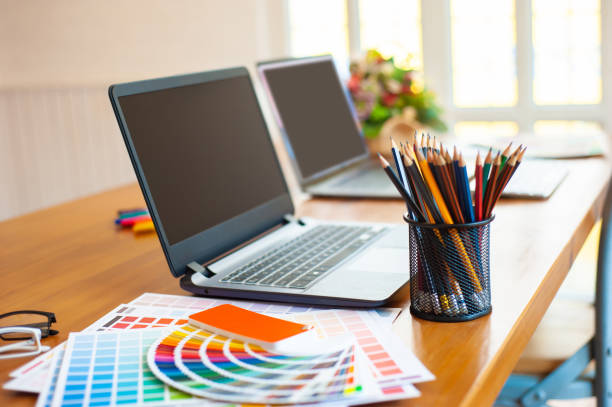 istock Designer's office desk with a laptop and work equipment. 1224081612