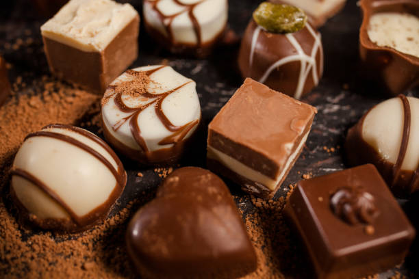 istock Box of assorted chocolates on black background 1224082311