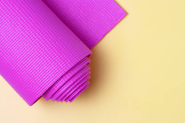 istock Pink sports mat on yellow background, top view, copy space 1224083590