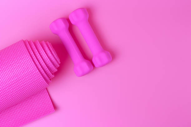 istock Pink dumbbells and mat on pink background, a view from above 1224083606