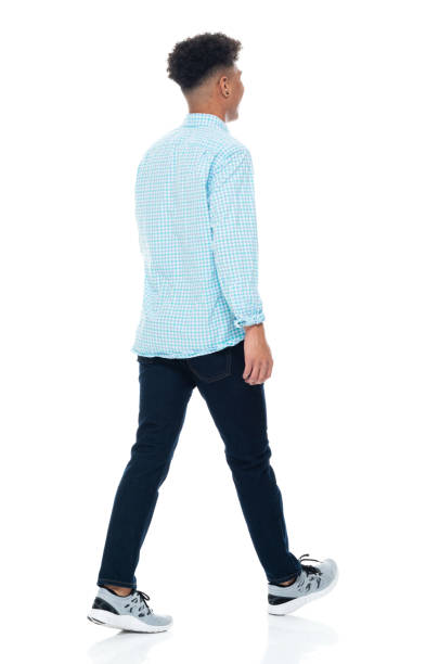 istock Generation z male walking in front of white background wearing pants 1224084331