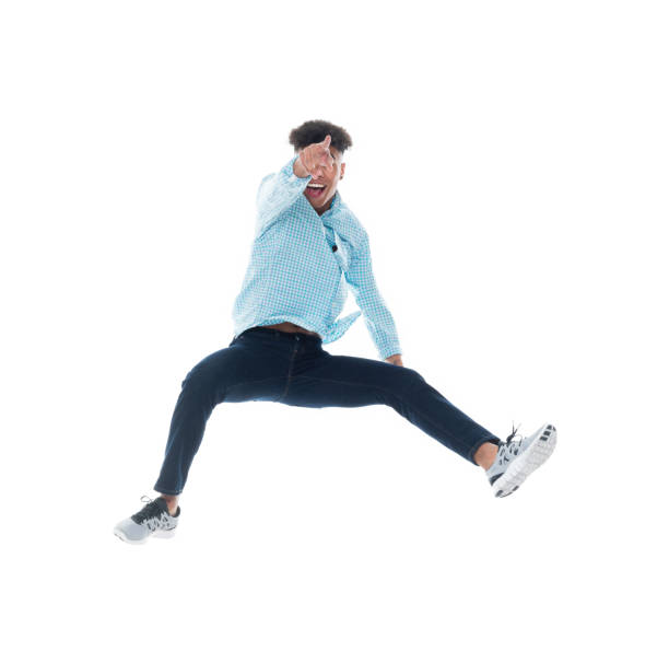 istock African ethnicity male falling in front of white background wearing pants 1224084530