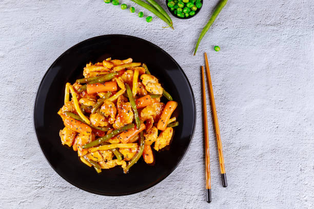 istock Sweet and spisy chicken and vegetable in black plate. 1224084553