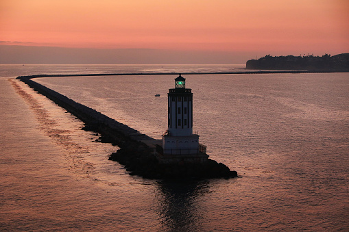 View of water and Port of Los Angeles Lighthouse at orange Sunset
