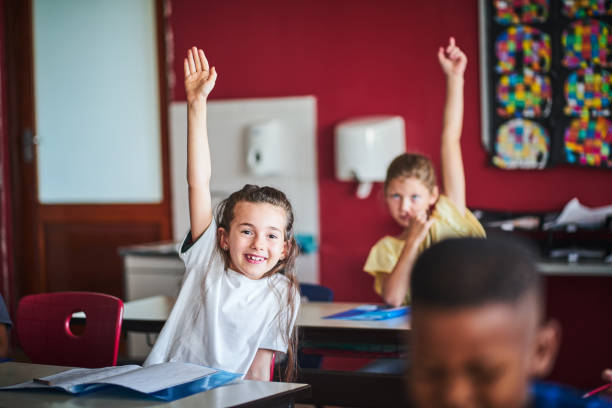 istock Excited girl answering in classroom 1224088081