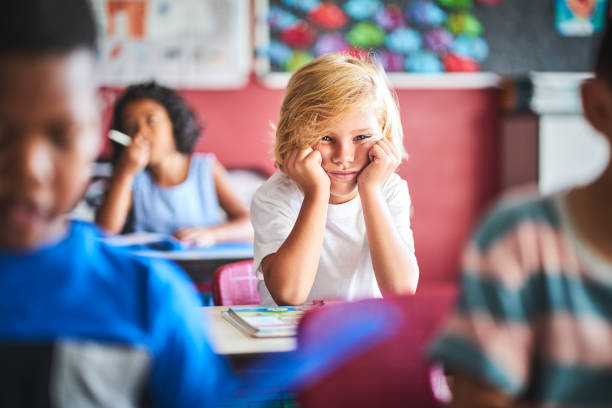 istock Bored boy listening at classroom in school 1224088092