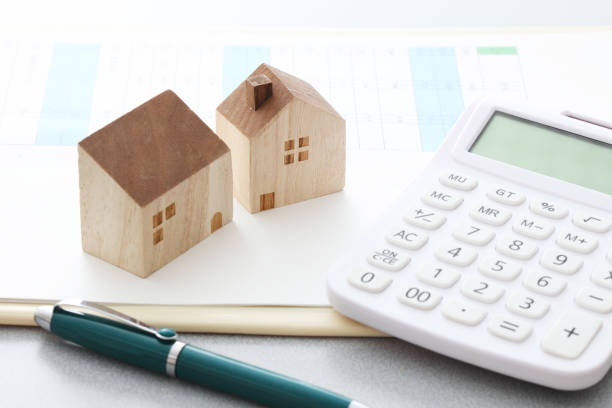 istock Miniature house and calculator 1224092181