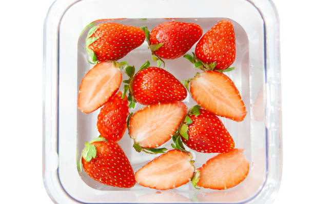 istock Fresh strawberry floating in water isolated on white background. 1224092499