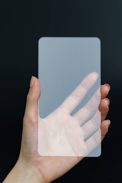 istock Hand holding and showing transparent smartphone. Business, technology concept. 1224094603