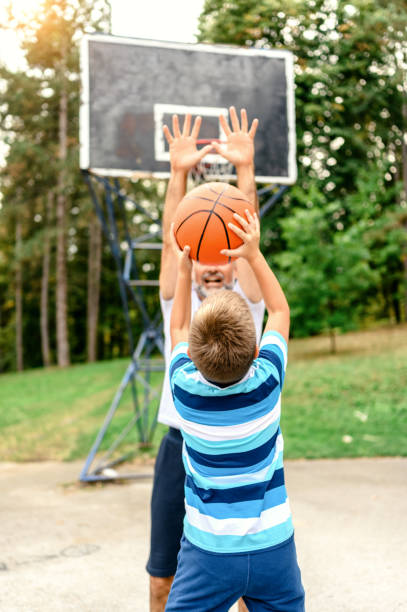 istock Father and son playing basketball 1224095560