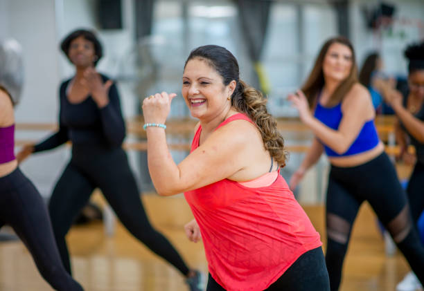 Dance fitness class Diverse group of women in dance fitness exercise class. zumba image stock pictures, royalty-free photos & images