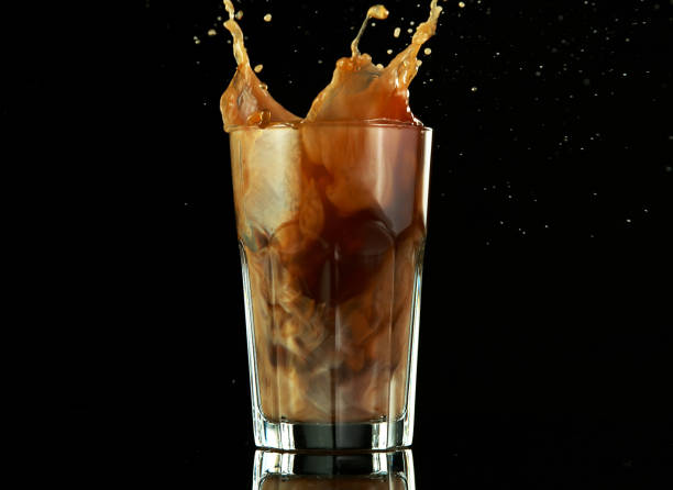 istock Splashing ice coffee drink on black background 1224099203