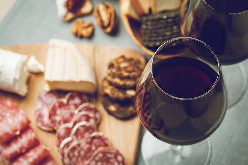 Two glasses of red wine with charcuterie assortment, beaujolais concept