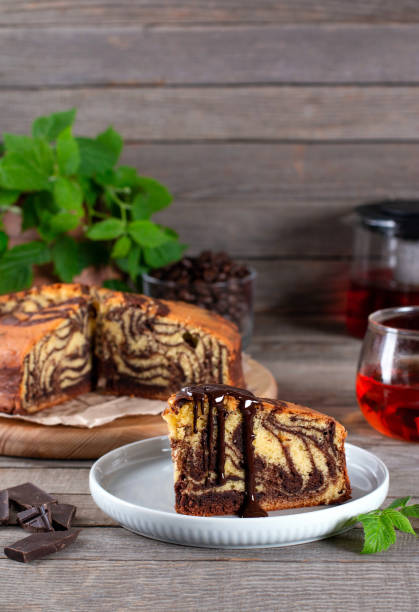 istock Chocolate marble cake slice with chocolate on wooden table 1224105406