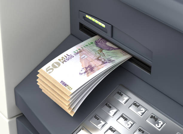 Withdrawal Colombian Pesos Withdrawal Colombian Pesos From The ATM colombian peso stock pictures, royalty-free photos & images