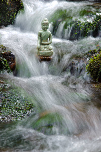 istock buddha sculpture is sitting in water cascade 1224107687