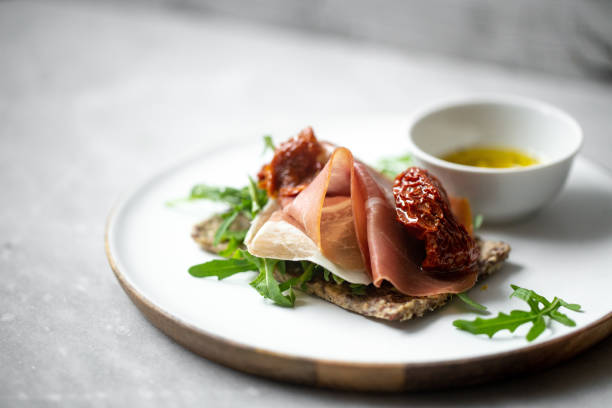iberico ham sandwich on marble background with copy space