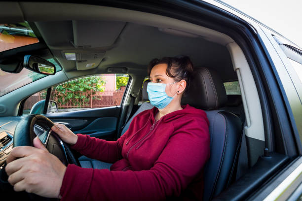 istock Female car driver wearing protective face mask 1224109863