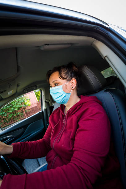 istock Female car driver wearing protective face mask 1224109910