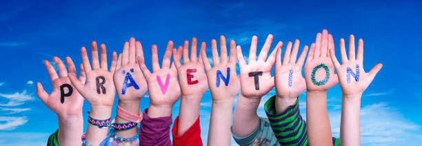 Children Hands Building Colorful German Word Praevention Means Prevention. Blue Sky As Background