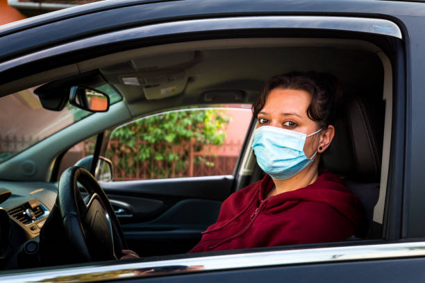 istock Female car driver wearing protective face mask 1224109958