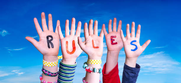 istock Children Hands Building Word Rules, Blue Sky 1224110021