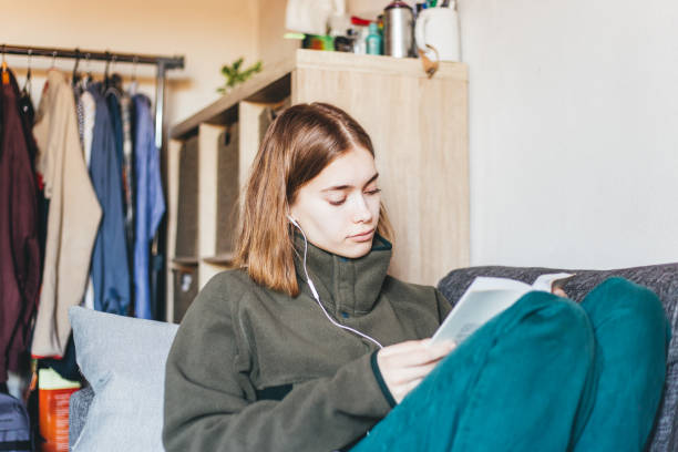 istock Woman reading at home 1224111496