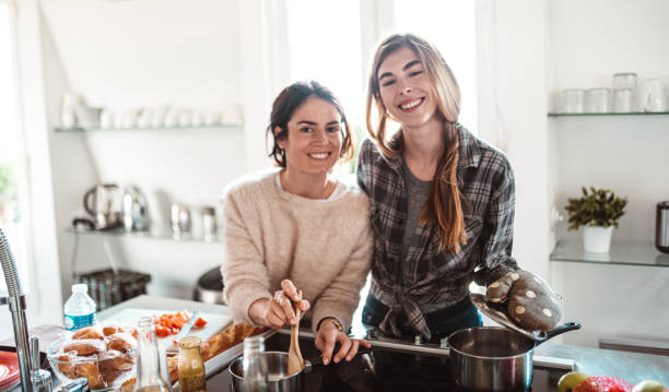 istock happiness friends cooking together at home 1224111764