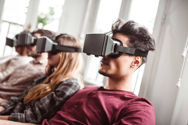 istock friends playing videogames with VR headset 1224112317