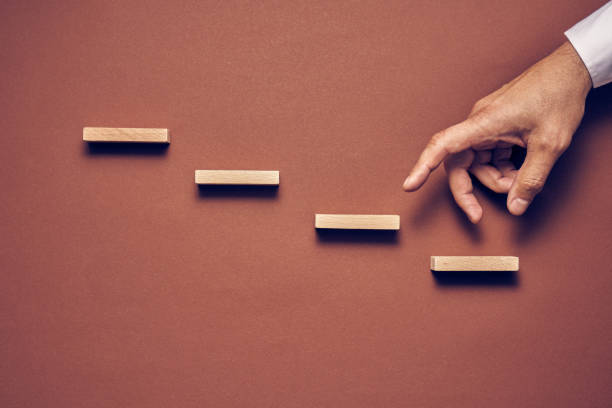 istock Men's hand and wooden blocks arranged in a conceptual image 1224113692