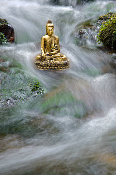 istock buddha sculpture is sitting in water cascade 1224114465
