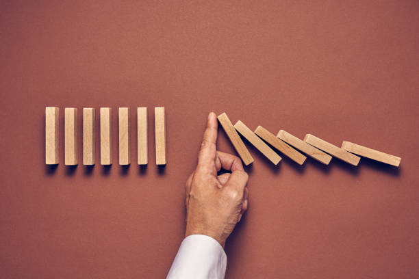 istock Men's hand and wooden blocks arranged in a conceptual image 1224114481