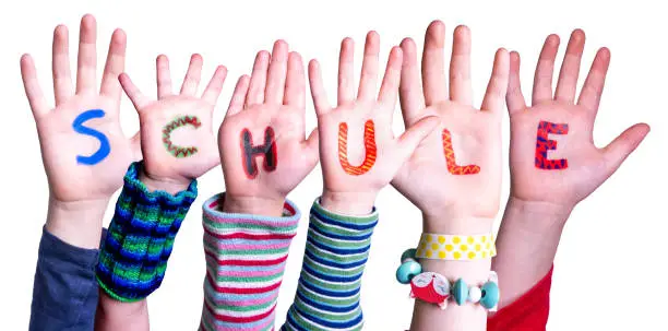 Children Hands Building Colorful German Word Schule Means School. Isolated White Background
