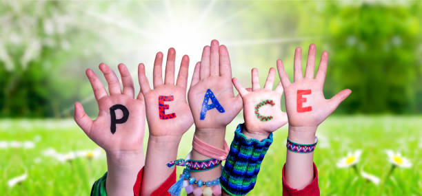 istock Children Hands Building Word Peace, Grass Meadow 1224117163