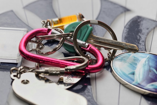 Abstract image of keys and accessories on colourful carabiner