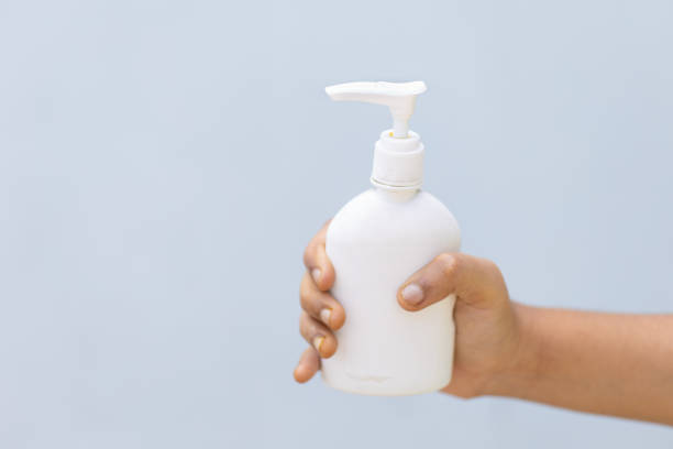 istock Child's hand with disinfectant hand sanitizer against plain background 1224119835