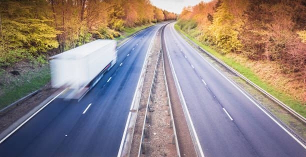 istock White truck on empty dual motorway in UK - drivers are key workers 1224121415