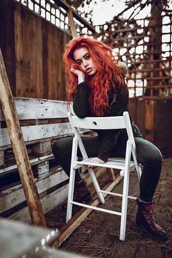 Female Beauty Relaxing On Wooden Chair