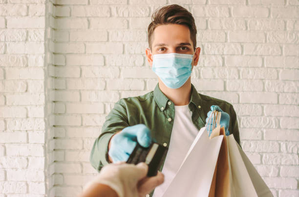 istock Hipster courier giving shopping bags and check out customer 1224125486