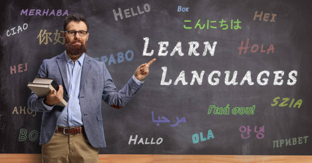 istock Language teacher in front of a blackboard with text learn languages 1224125935