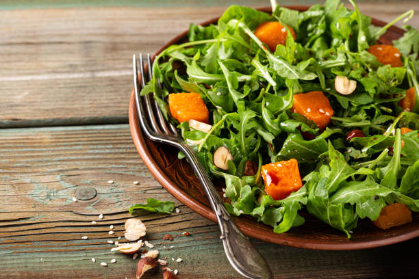 Delicious salad with arugula and baked pumpkin