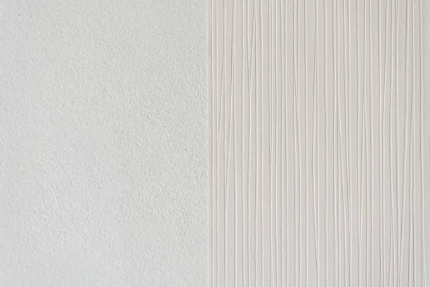 istock Installing striped wallpaper on a concrete wall in the bedroom 1224128488