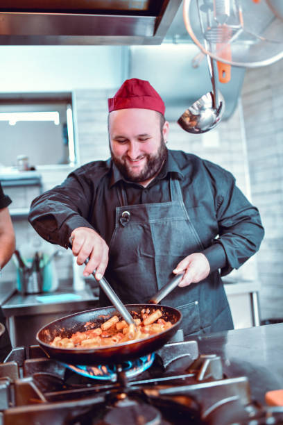 istock Smiling Male Chef Cooking Exotic Pasta In Restaurant 1224128929