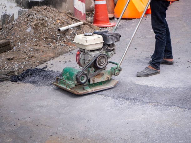 istock Worker use vibratory plate compactor compacting asphalt at road repair 1224130315