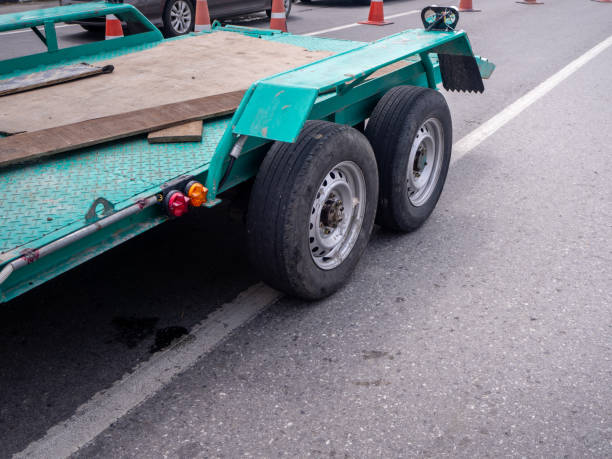 istock transporting small  cargo trailer for a car strapped on the road 1224130434
