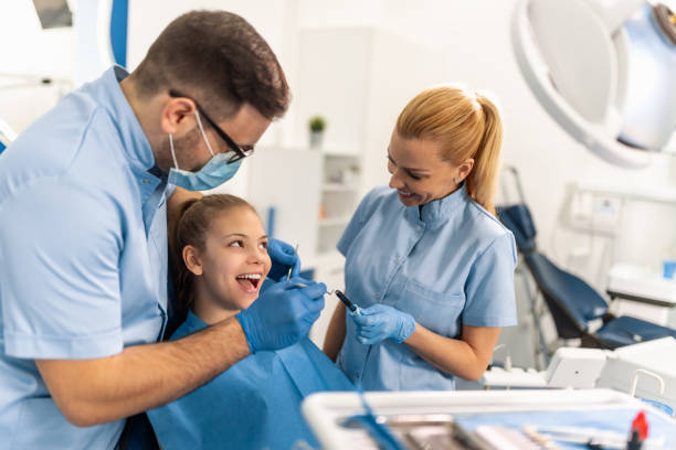 Dentist and patient in dentist office. stock photo