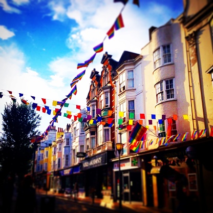 Rainbow flags decorating street in Brighton UK. Brighton and Hove Pride is an annual event held in the city of Brighton and Hove, England, organised by Brighton Pride, a community interest company who promote equality and diversity, and advance education to eliminate discrimination against the lesbian, gay, bisexual and trans community.